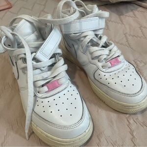 white Nike Air Force 1 mid-top sneaker.